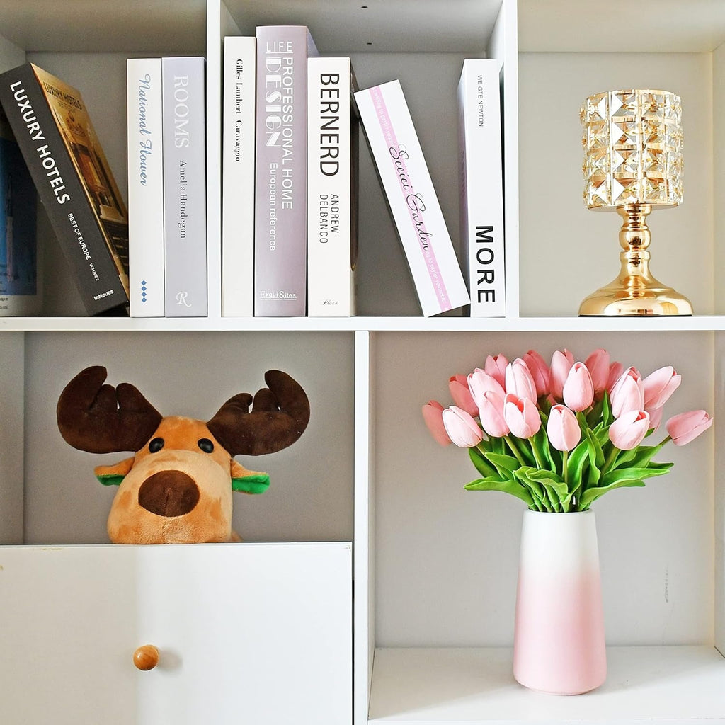 Bookshelf with books, decorative lamp, plush moose, and pink tulips in a vase.