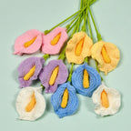 Colorful crocheted flowers on a light green background