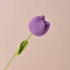 Knitted purple flower on a beige background