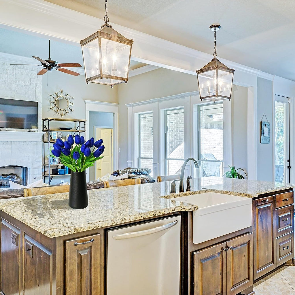 Modern kitchen with wooden cabinets, marble countertops, and pendant lights.