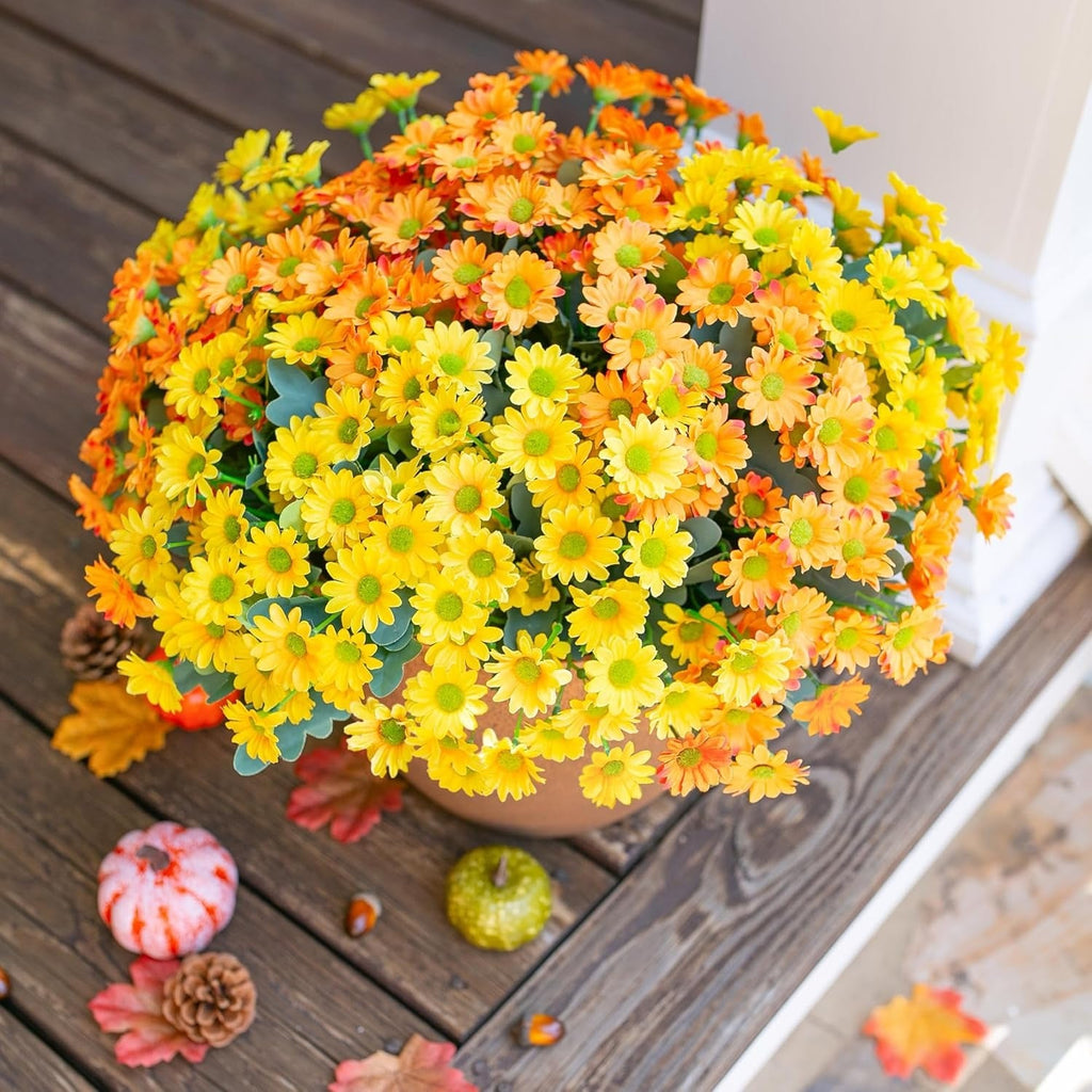 Potted plant with yellow and orange flowers on a wooden surface