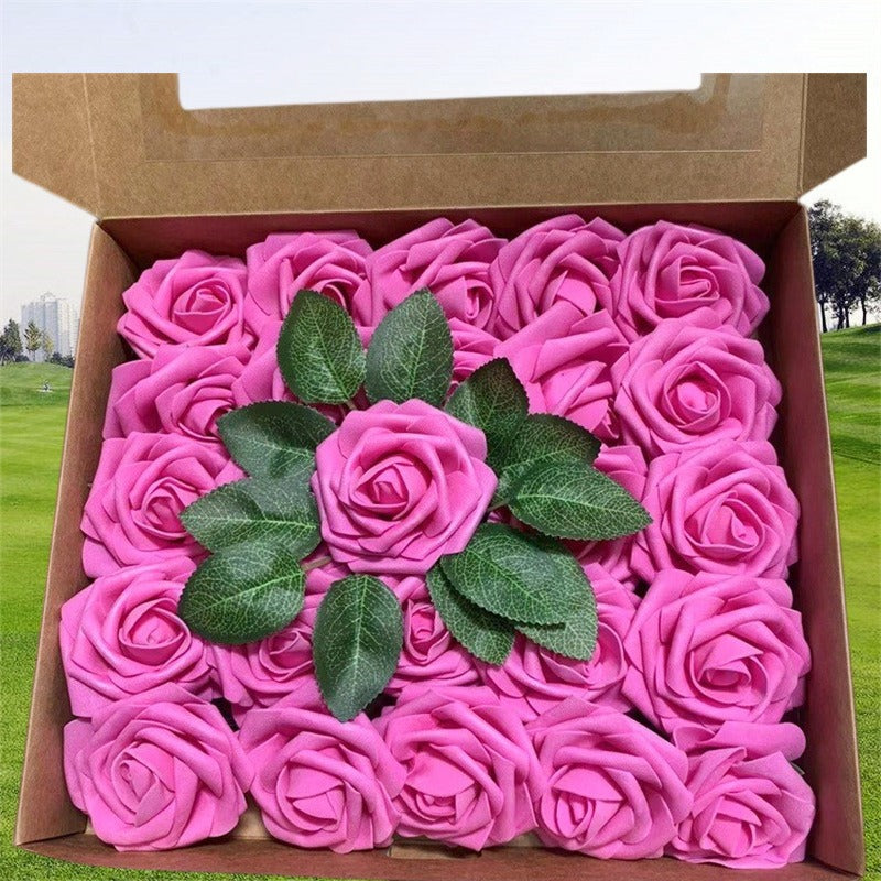 Box of pink roses with green leaves on a grassy background