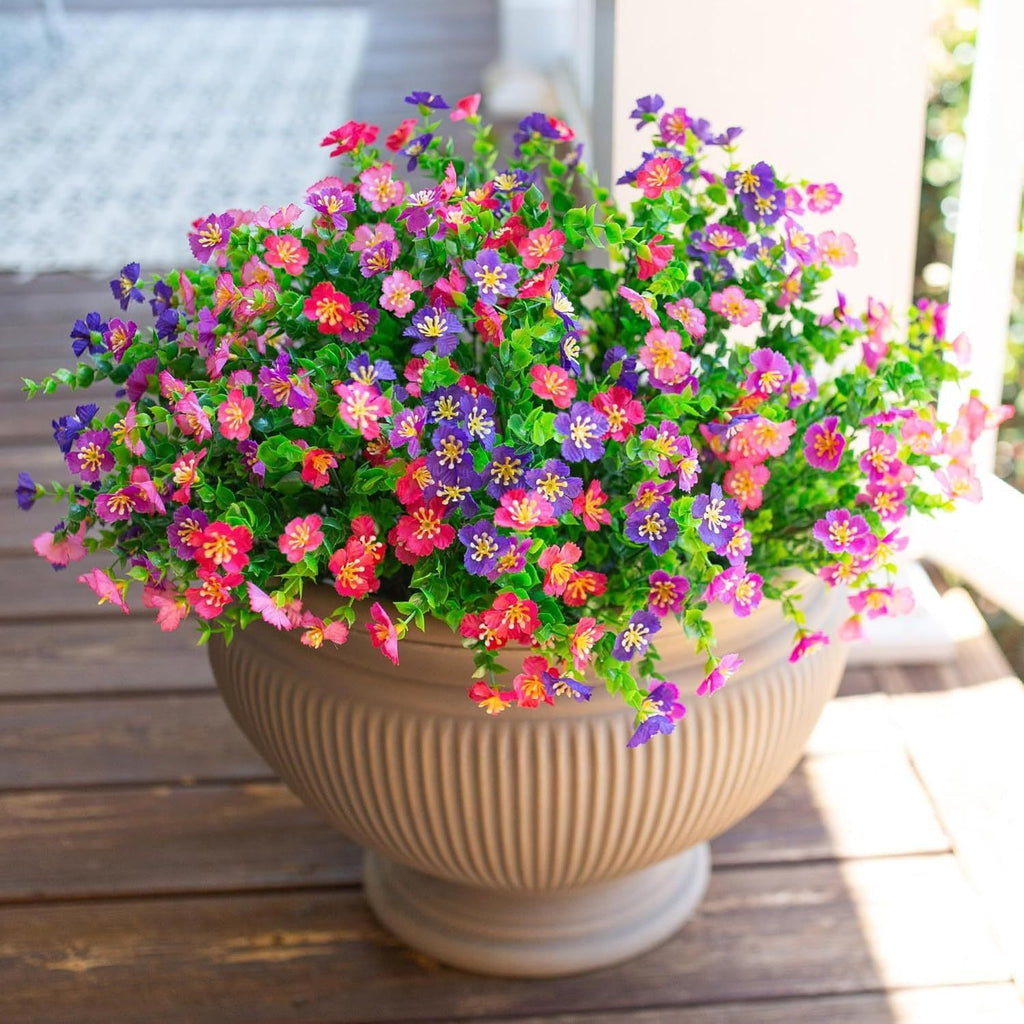 Potted plant with colorful flowers on a wooden surface