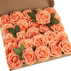 Box of peach-colored roses with green leaves on a white background