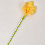 Yellow crocheted flower on a white background