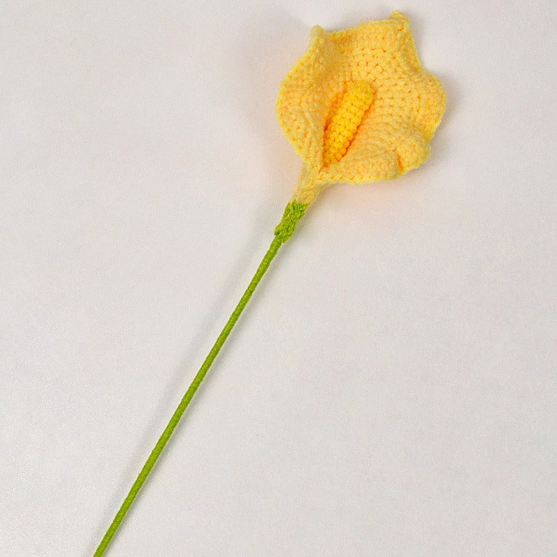 Yellow crocheted flower on a white background
