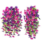 Two artificial hanging flower baskets with pink and purple flowers on a white background