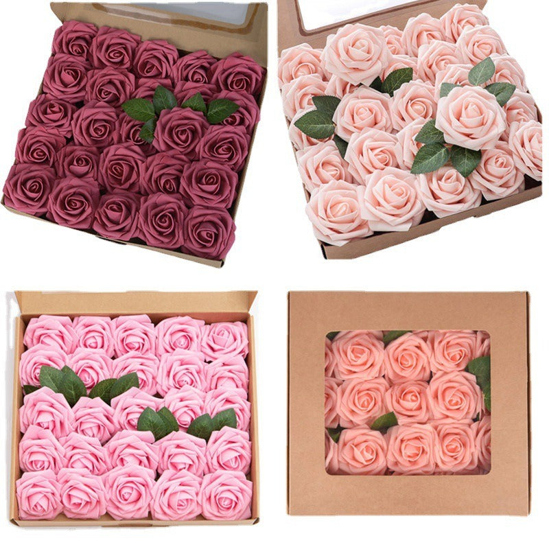 Four boxes containing pink and red artificial roses with green stems.