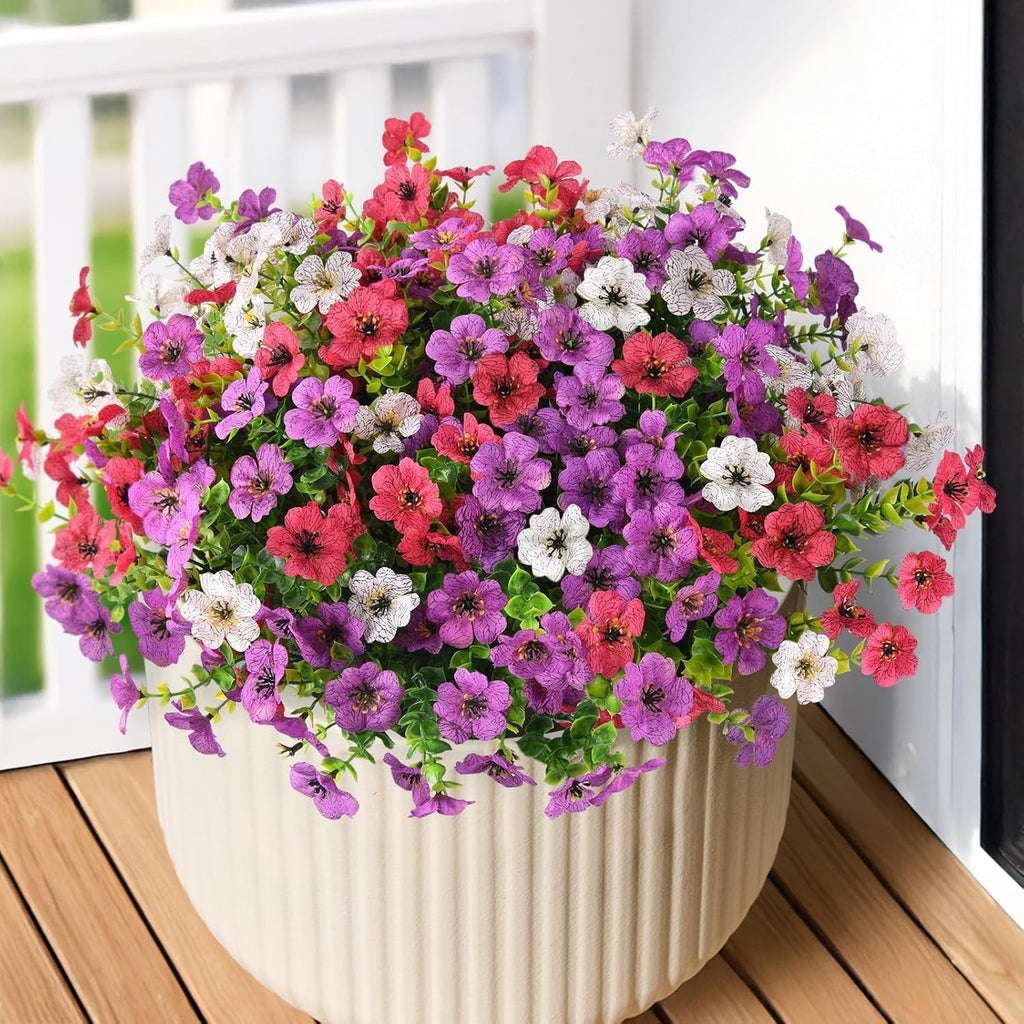 Potted plant with multicolored flowers on a wooden deck
