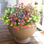 Potted plant with colorful flowers on a wooden deck