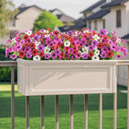 Floral planter box on a deck with houses in the background