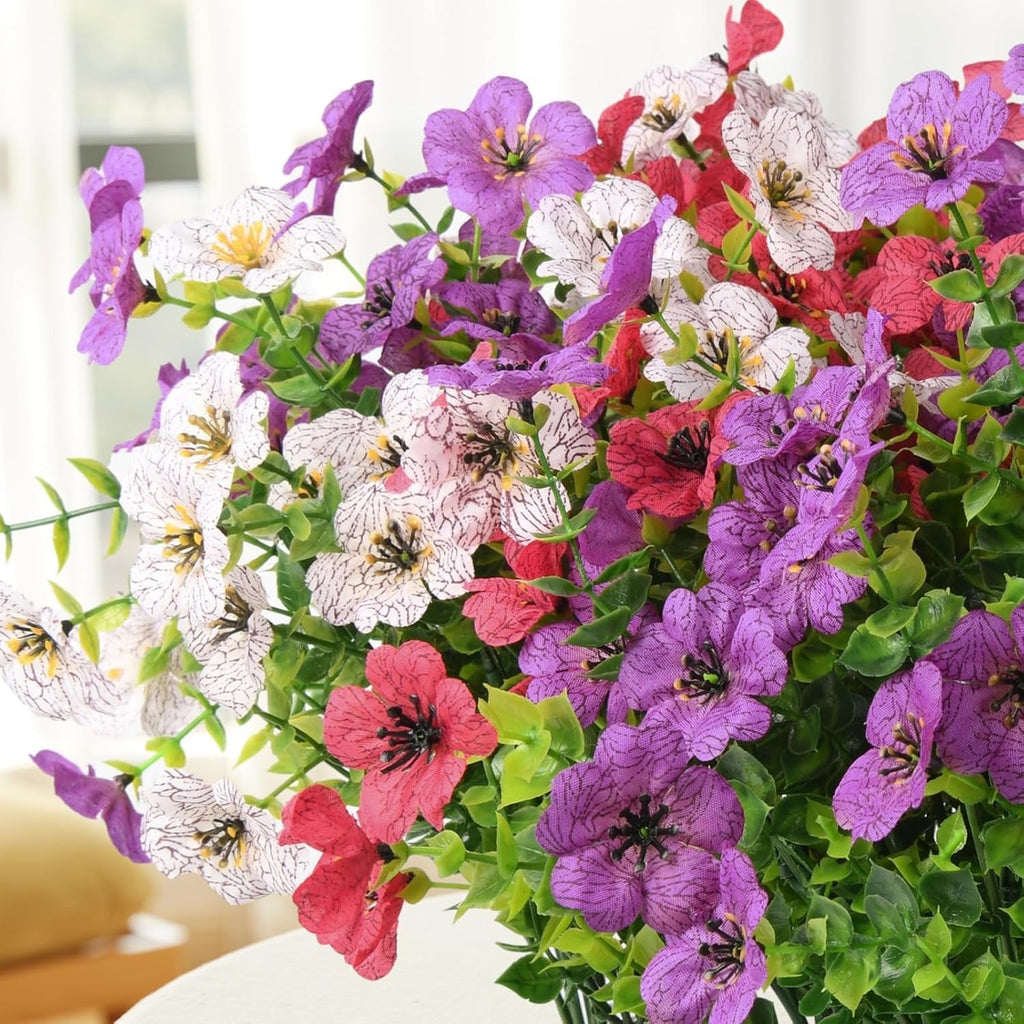 Bouquet of colorful flowers including purple, white, and pink.