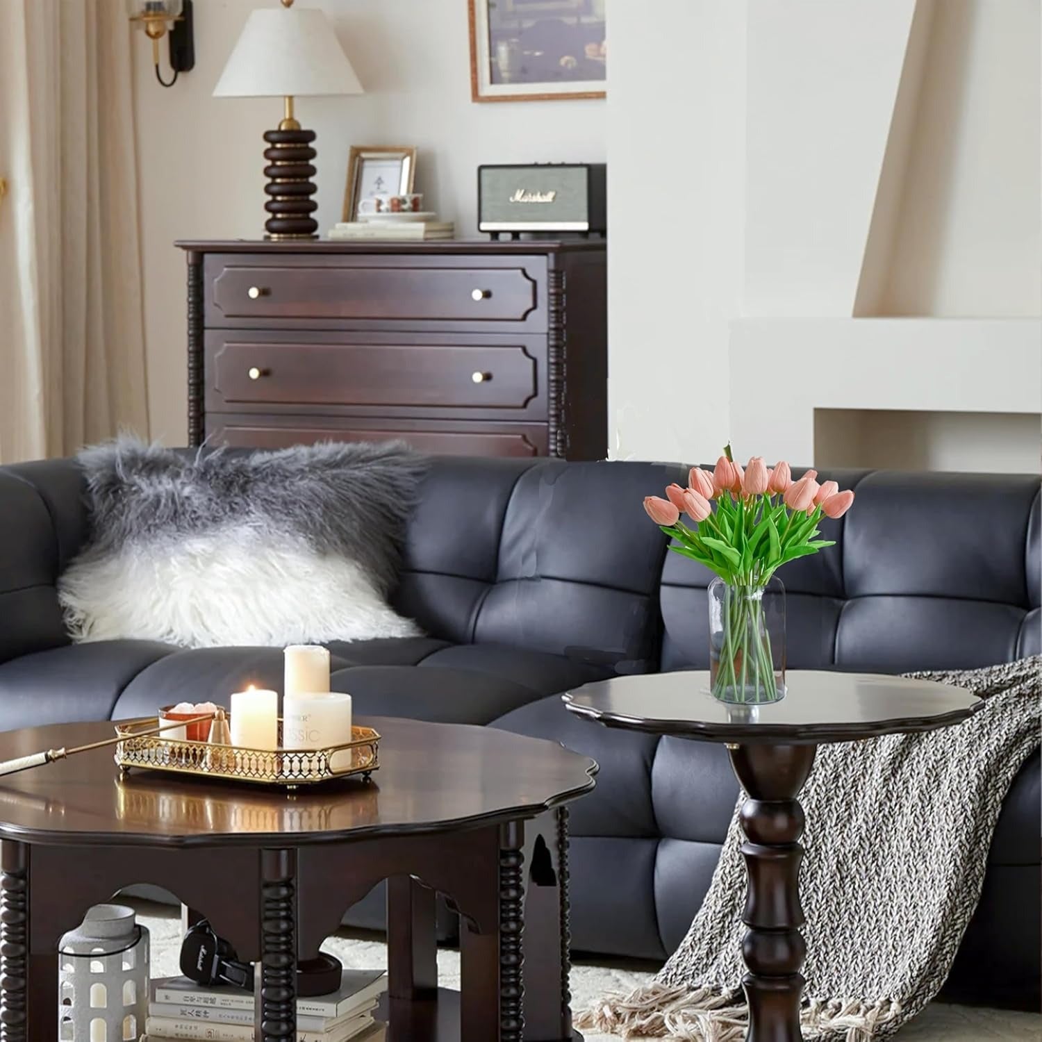 Living room with a dark gray sofa, wooden coffee table, and decorative items.