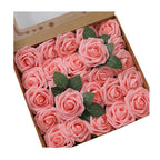 Box of pink rose-shaped soap bars with green leaves on a white background