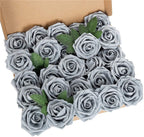 Heart-shaped arrangement of gray roses with green leaves in a cardboard box.