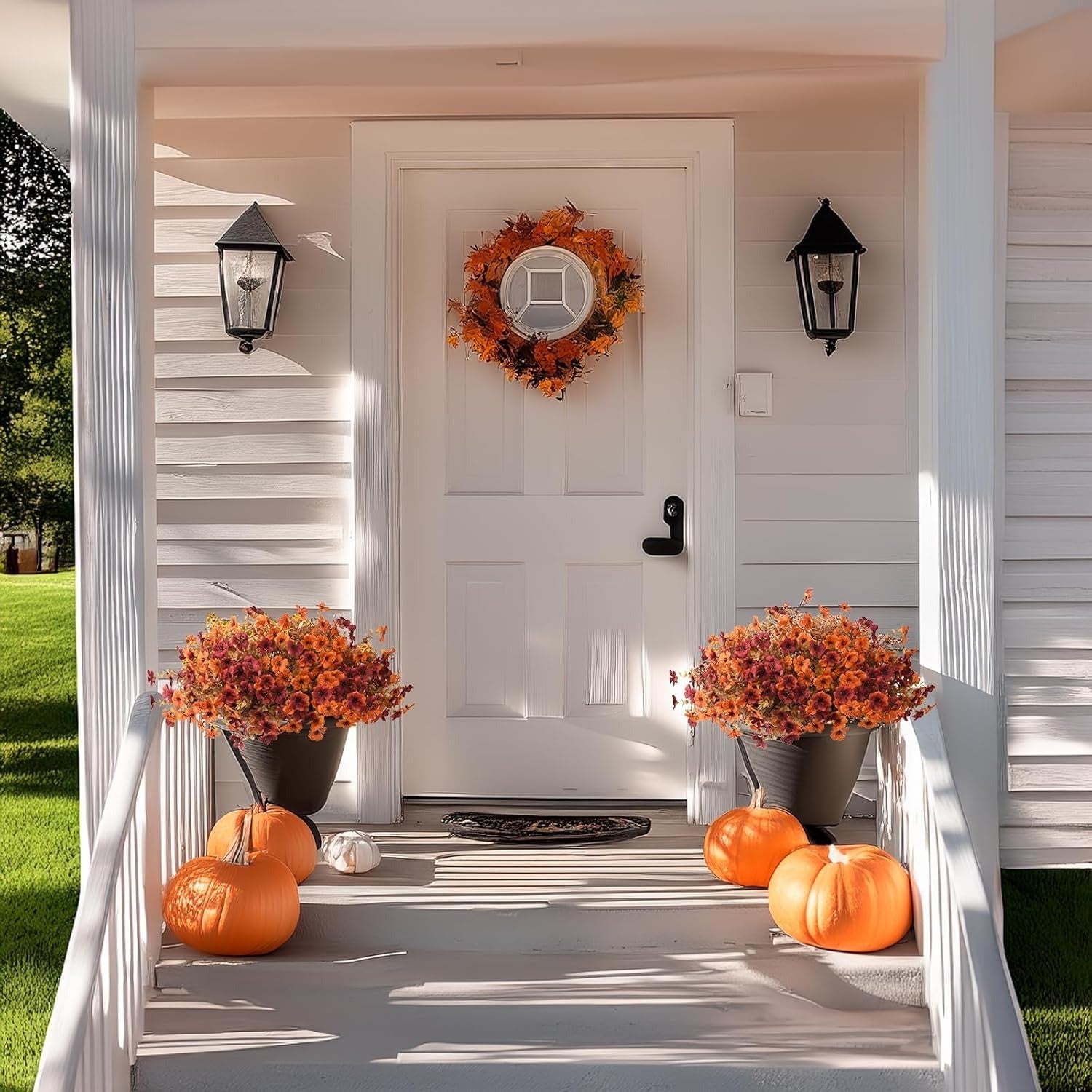 Front door with autumn decorations including pumpkins, flowers, and a wreath.