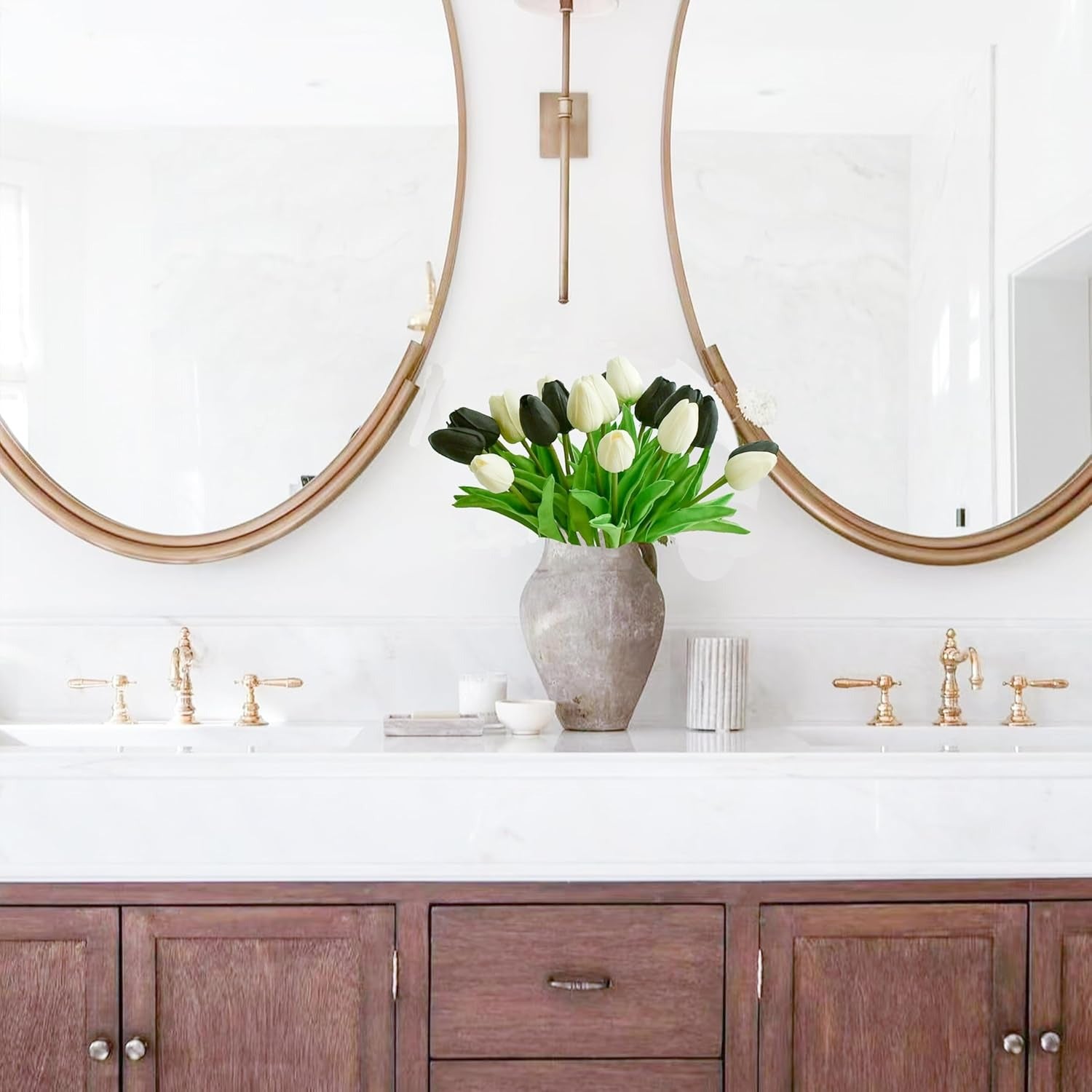 Bathroom vanity with wooden cabinets, white countertop, and decorative vase with flowers.
