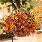 Decorative hanging basket with colorful flowers on a blurred garden background