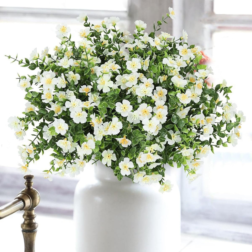 White flowers in a white vase on a blurred background