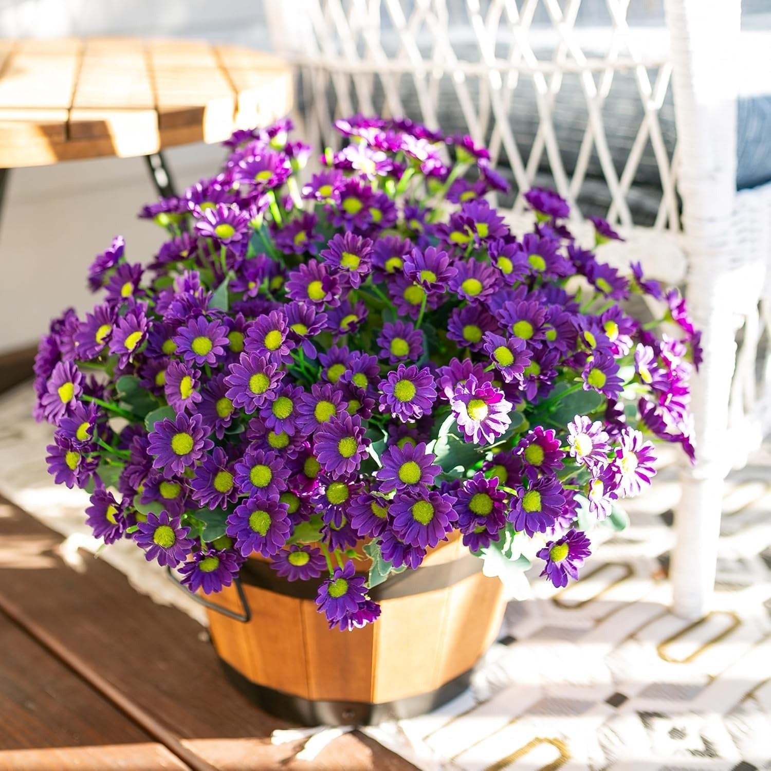 Potted purple flowers with green centers on a wooden surface