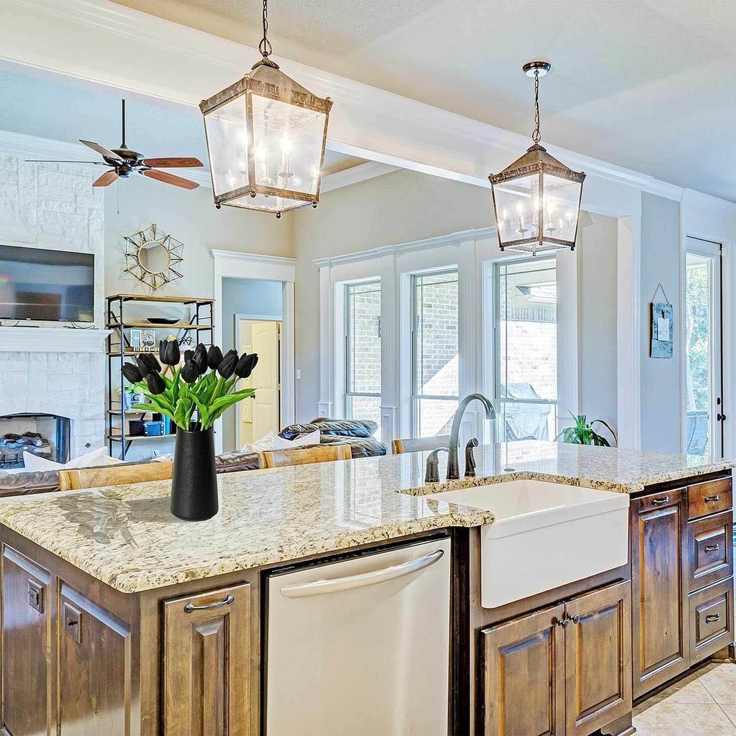 Modern kitchen with wooden cabinets, granite countertops, and a vase of tulips.