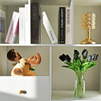 Bookshelf with books, a gold lamp, a plush moose, and a vase of black tulips.