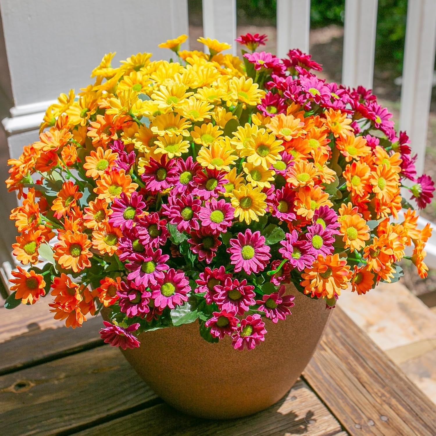 Colorful potted flowers on a wooden surface