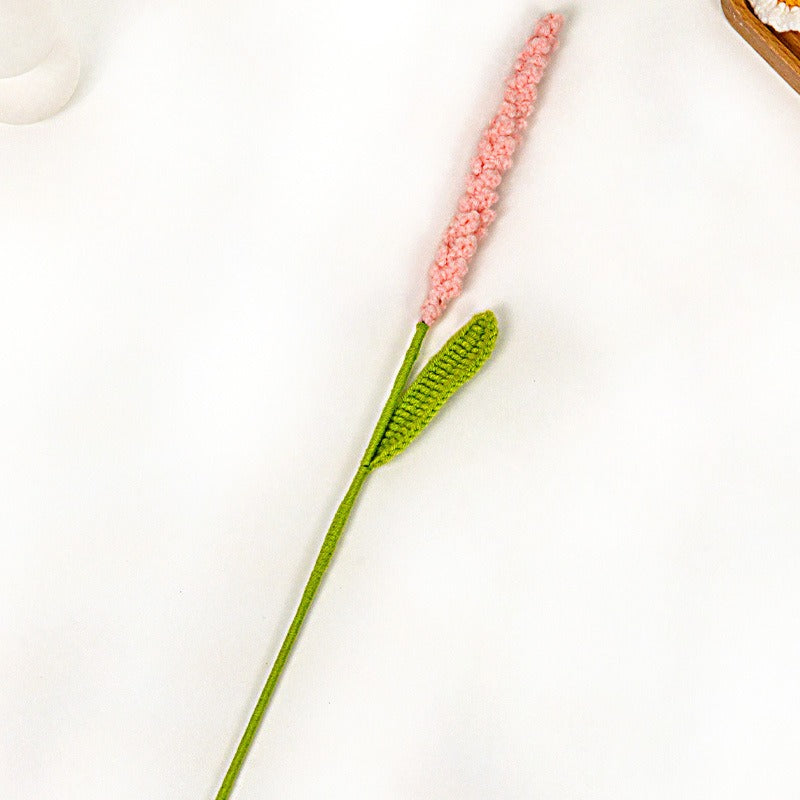 Decorative flower with pink petals and green stem on a white background