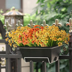 Floral planter hanging on a metal railing with a blurred garden background
