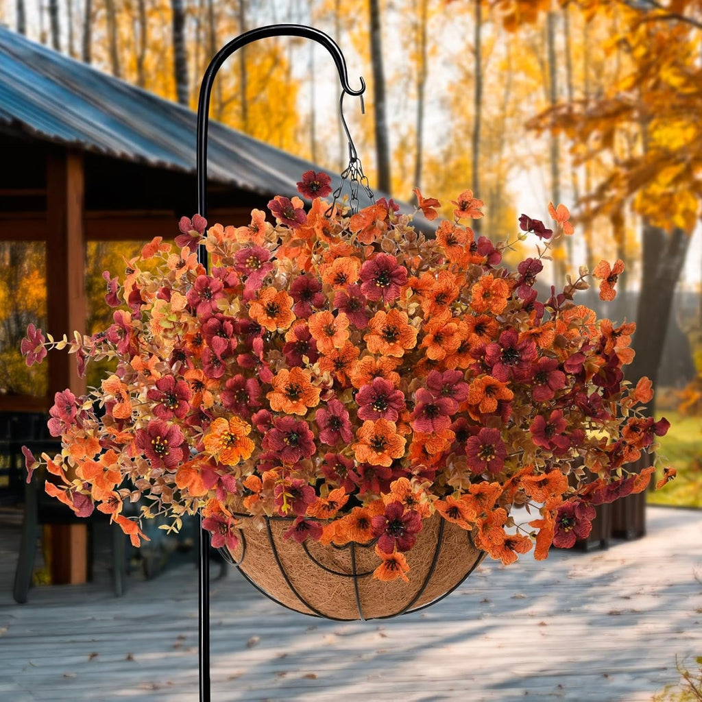 Hanging basket with autumn-colored flowers in a garden setting