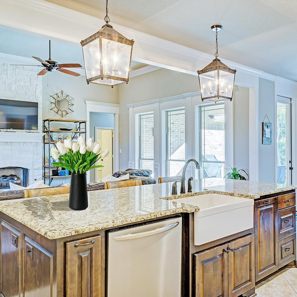 Modern kitchen with wooden cabinets, marble countertops, and pendant lights.
