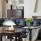 Living room with a dark leather sofa, wooden coffee table, and decorative items.