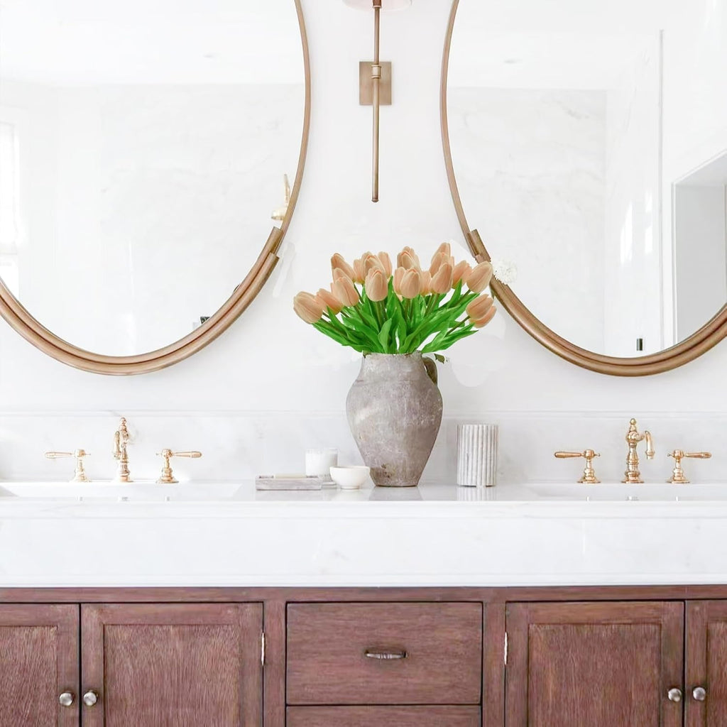Bathroom vanity with wooden cabinets, white countertop, and decorative vase with tulips.