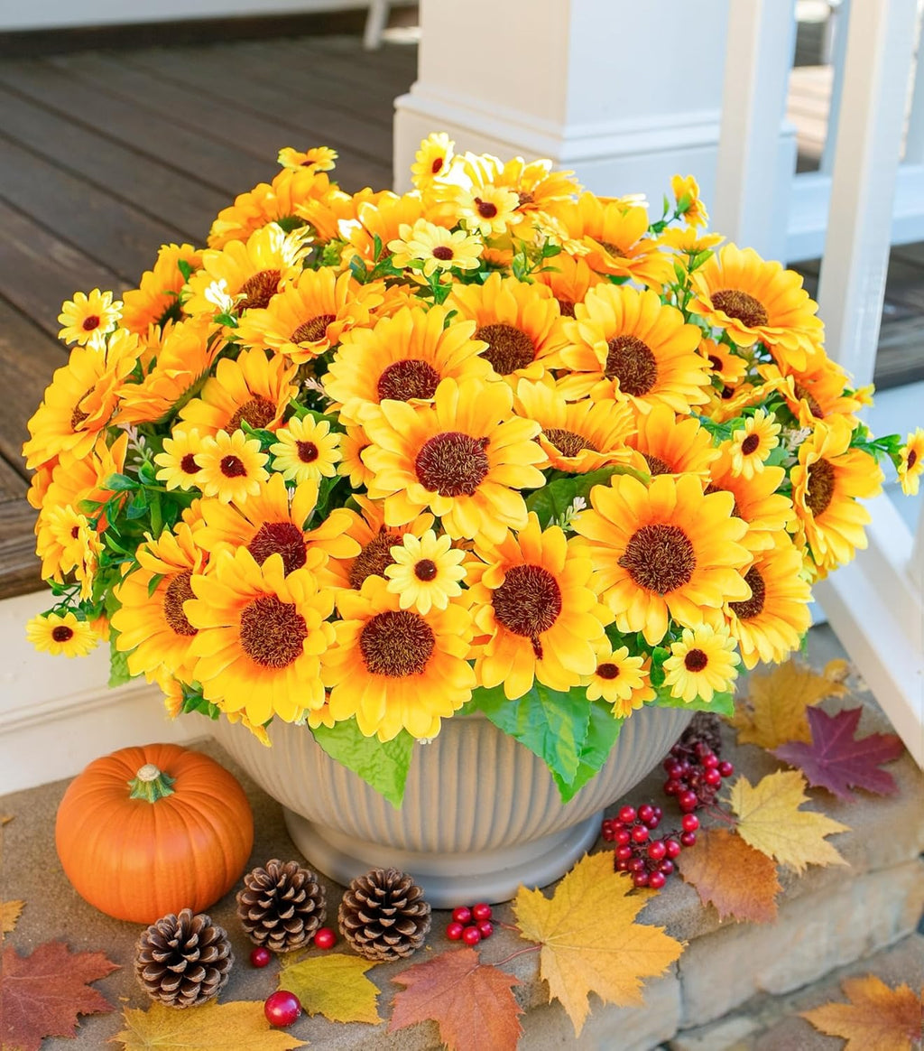 Potted sunflower arrangement with pumpkins and pinecones on a porch