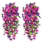 Two artificial hanging flower arrangements with pink and purple flowers on a white background