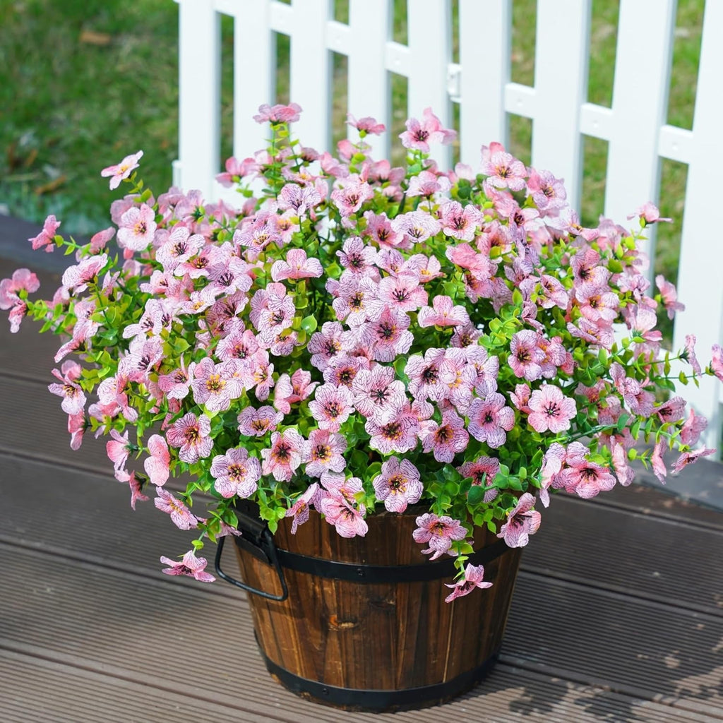 Potted plant with pink flowers on a wooden deck