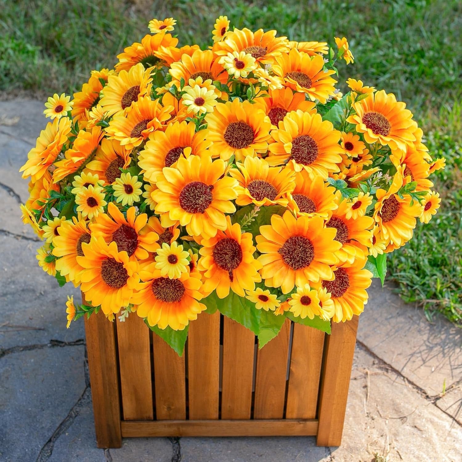 Bouquet of bright yellow sunflowers in a wooden planter against a natural background.