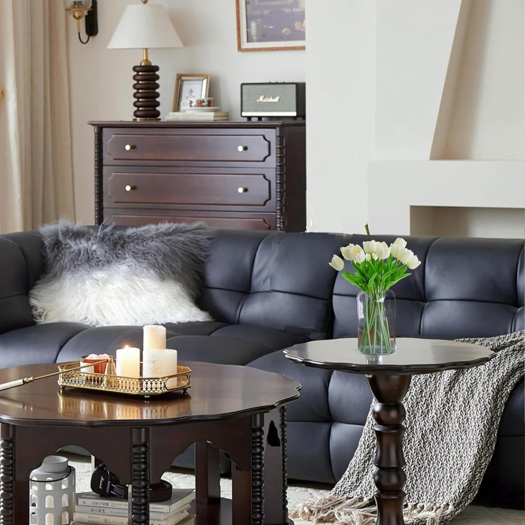 Living room with a dark gray sofa, wooden coffee table, and decorative items.