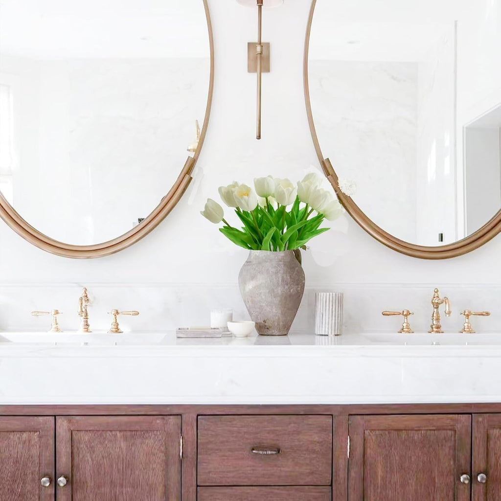 Bathroom vanity with wooden cabinets, white countertop, and decorative vase with flowers.