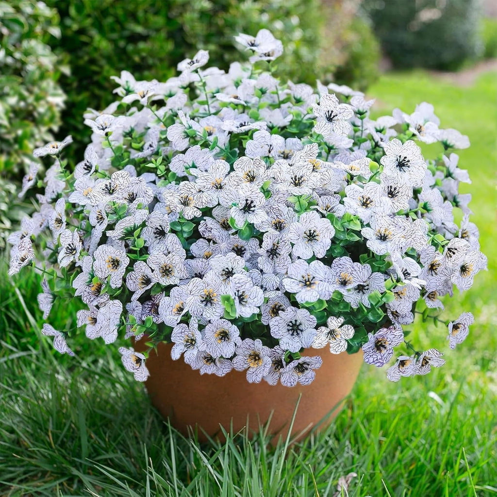 Potted plant with white flowers in a garden setting