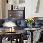 Living room with a dark gray sofa, wooden coffee table, and decorative items.