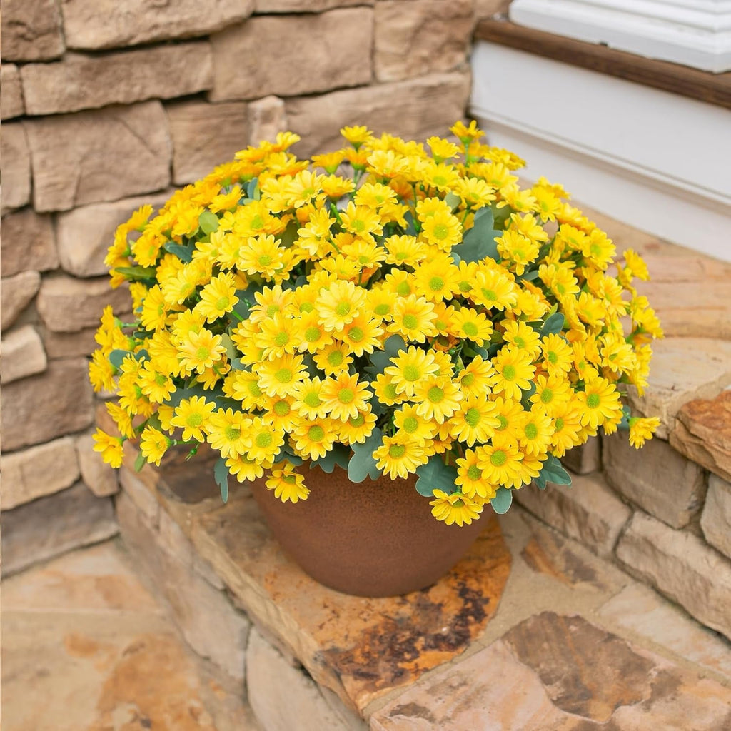 Potted yellow flowers on a stone ledge