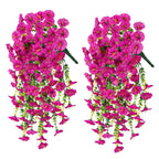 Two pink hanging floral arrangements on a white background