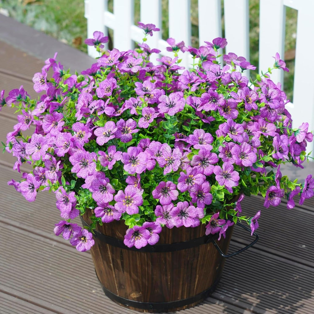 Potted purple flowers on a wooden deck