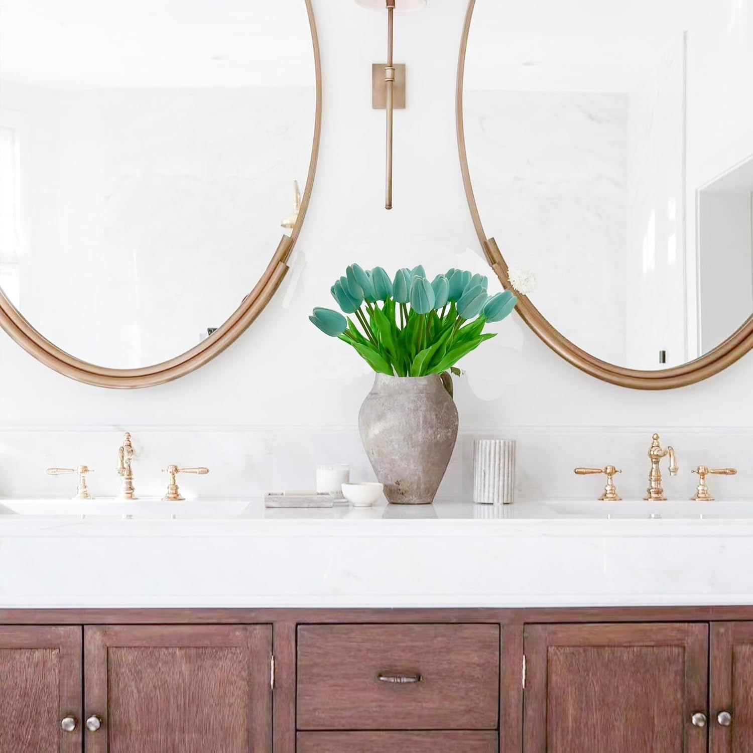 Bathroom vanity with wooden cabinets, white countertop, and decorative elements.