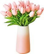 Bouquet of pink tulips in a gradient pink and white vase on a white background