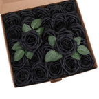 Box of black roses with green leaves on a white background