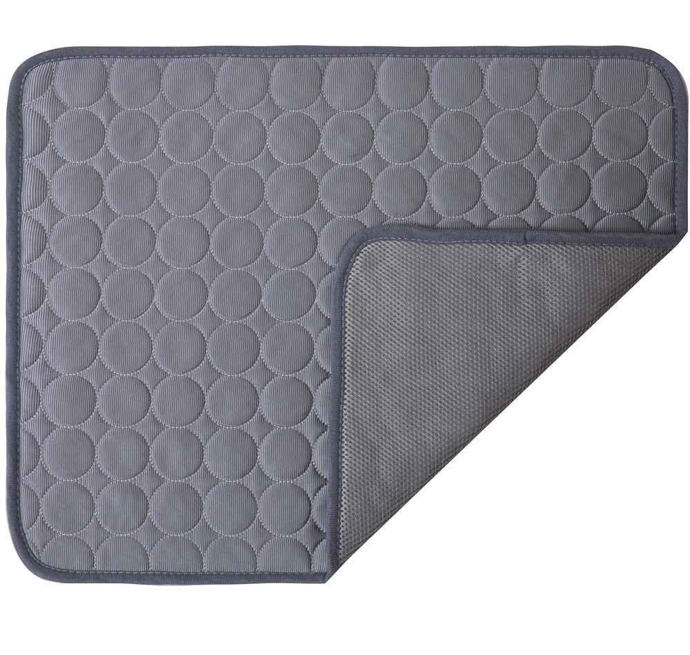 Gray quilted mat with circular pattern on a white background
