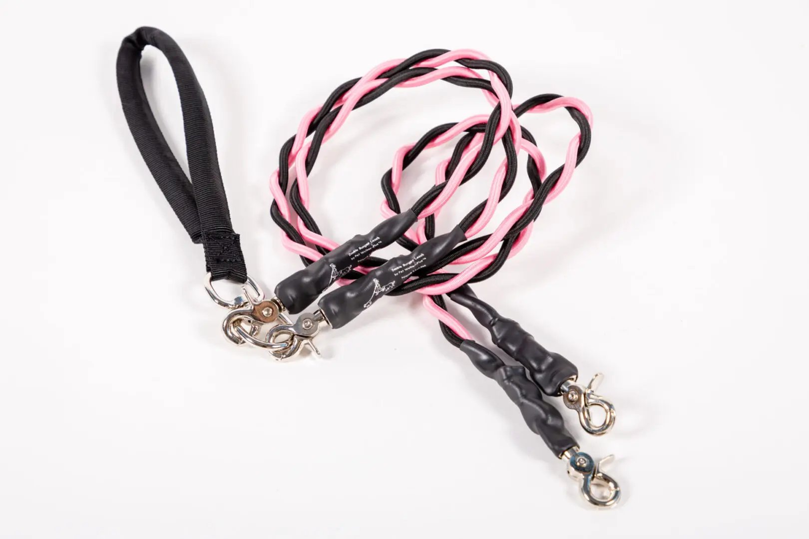 Two dog leashes with black and pink braided design on a white background